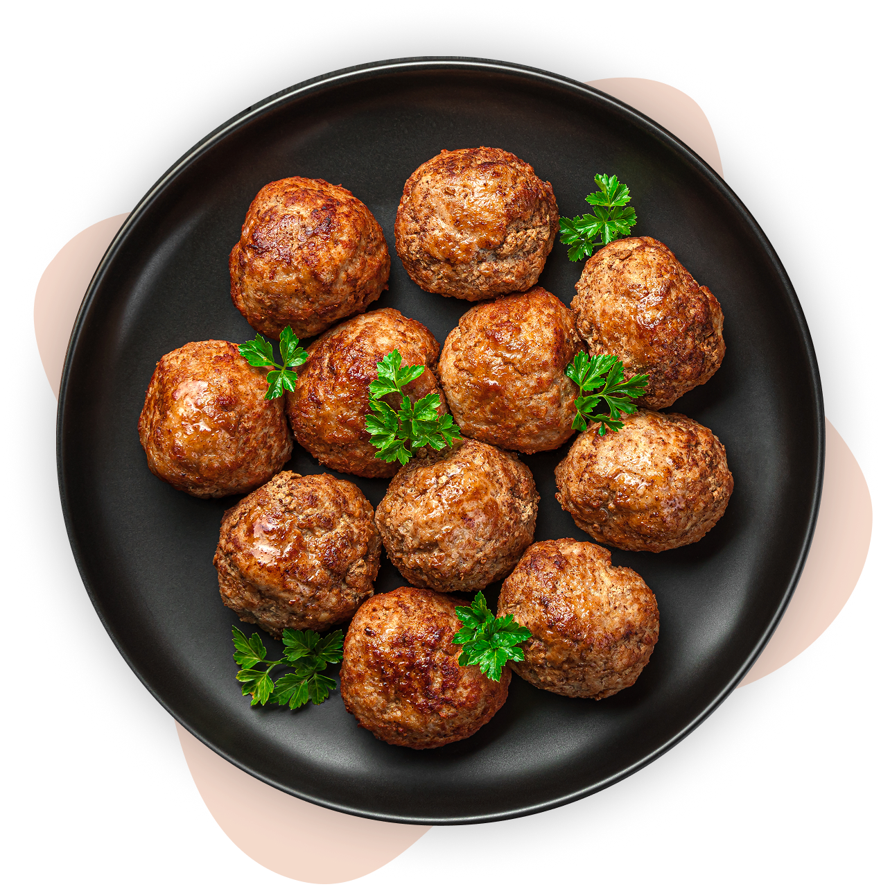 Meatballs with parsley on a black plate.
