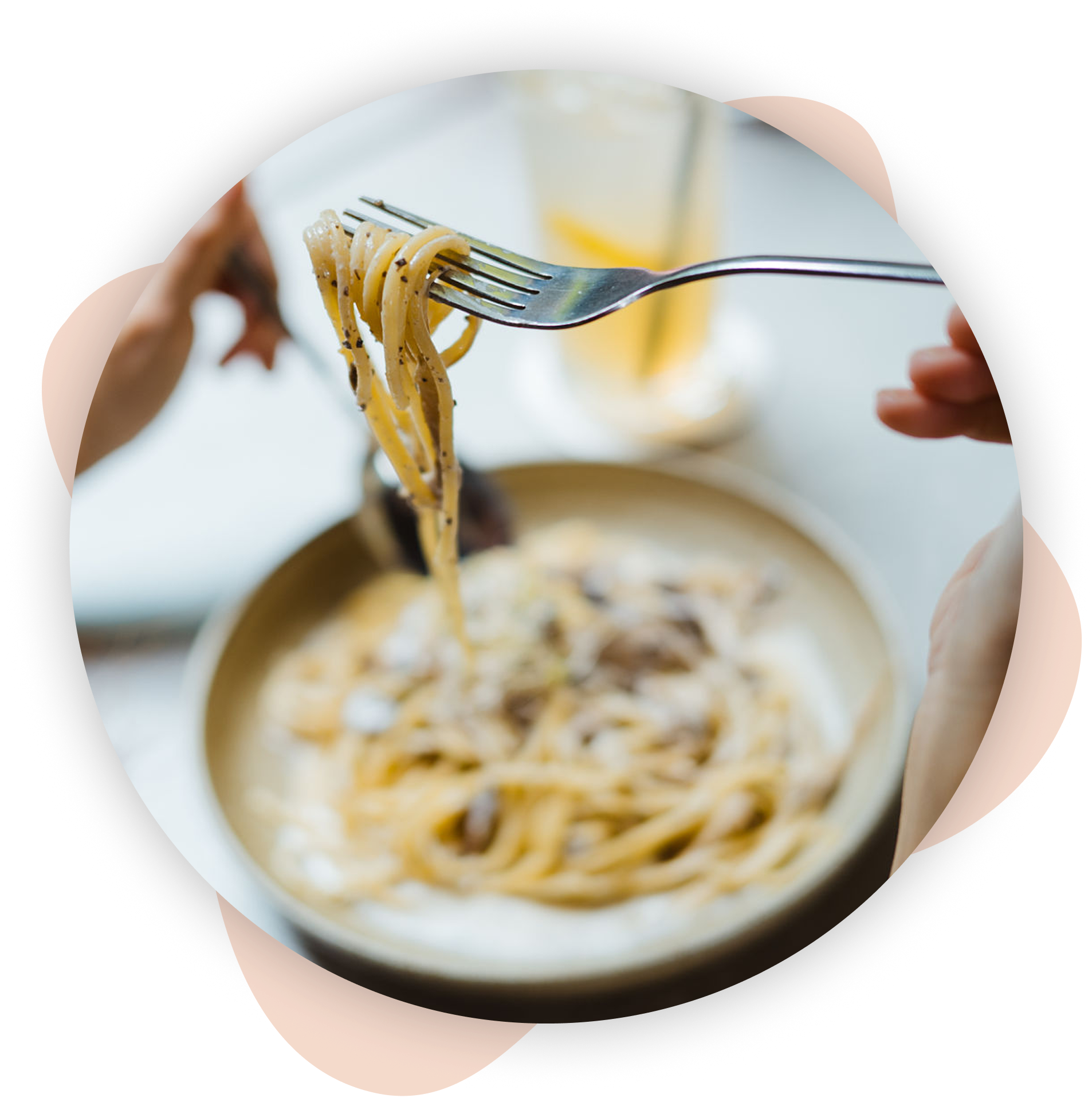 Fork lifting spaghetti from bowl.